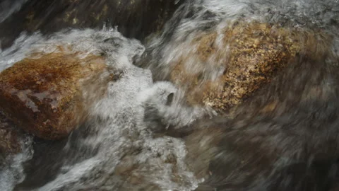 Rushing river water flowing over rocks Видео 331795576