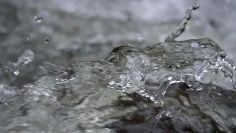 Rushing river water splashing creating waves extreme close up in slow motion Stock Footage 107045006