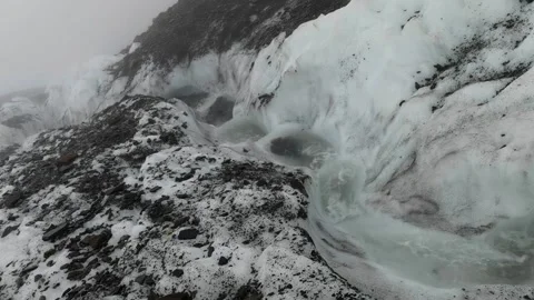 A rushing stream flows over a glacier Stock Footage 175343875