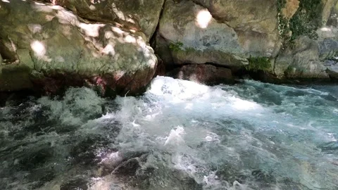 A rushing stream of water bursts out of the ground Stock Footage 158146602