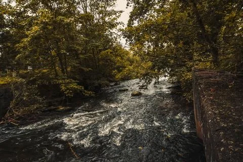 Rushing streams of a small river flow through natural obstacles Stock Photos