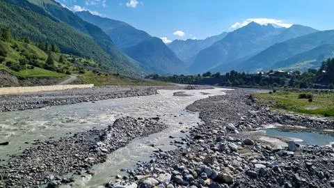 A rushing torrent going down through a stony bank in Caucasus, Georgia. The.. Stock Photos