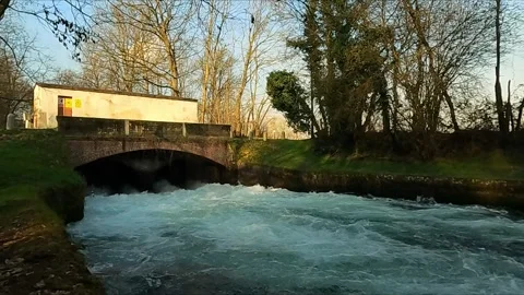 Rushing torrent passing under the bridge Stock Footage 306329486