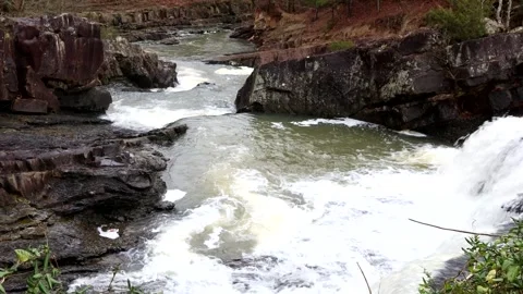 Rushing Water falls as a waterfall over a ledge, 4k 動画素材 338192998