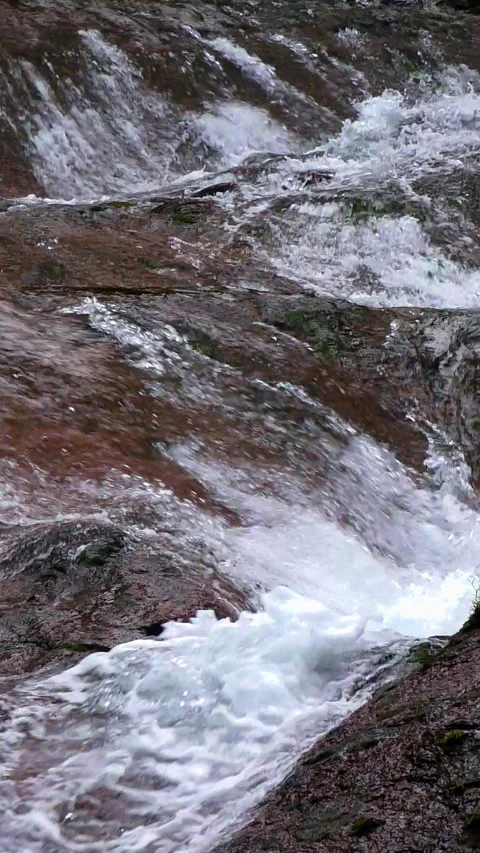Rushing Water Over Red Rock Slab Close Up Vertical Video Stock Footage 346191709