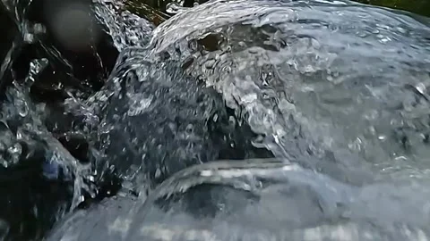 Rushing water torrents create abstract clear patterns, slow motion scene Stock Footage 312381403