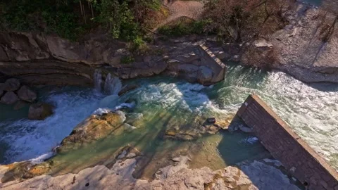 Rushing water winds through stone gorge in spring landscape Stock Footage 307316077