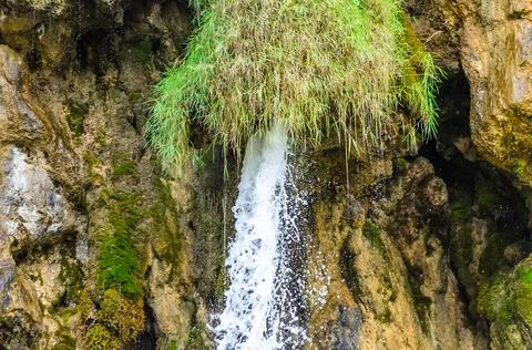 Rushing Waters Flowing with High Speed from a Waterfall. Water Flow through Rock Stock Photos