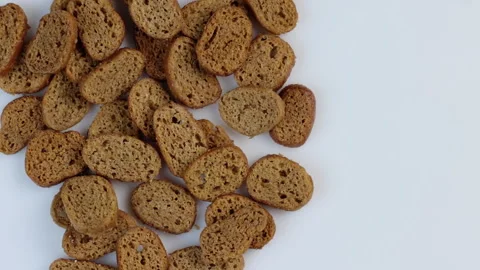Rusks of dark wheat bread spinning in a circle on a white background. The Stock Footage 145651098