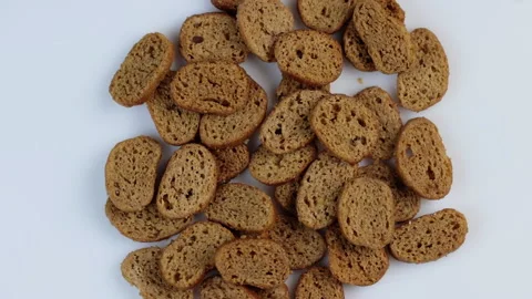 Rusks of dark wheat bread spinning in a circle on a white background. The Stock Footage 145651601