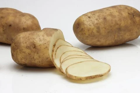 Russet Baking Potatoes assorted on white background Photos