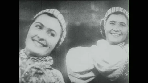 Russia 1940s:People dance on parade float. Hands play accordion. Women smile and Stock Footage 213951109