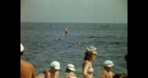Russia - circa 1970s: Authentic Soviet era lifestyle, crowded beach Video stock 332547102