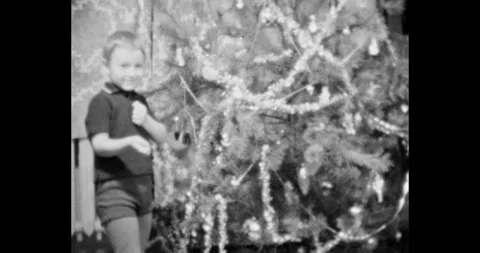 Russia - circa 1970s: Boy decorating a festive tree, vintage USSR Stock Footage 328360499