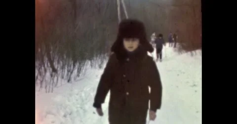 Russia - circa 1970s: Soviet boy in a traditional ushanka hat walking Video stock 328114892