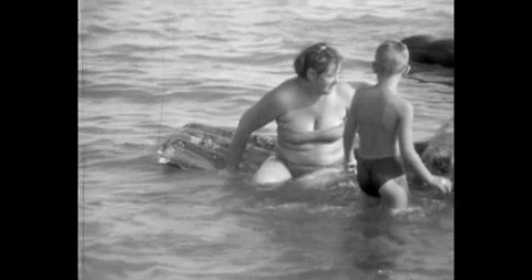 Russia - circa 1970s: Soviet era family vacation at the beach, woman and child Stock Footage 324898507