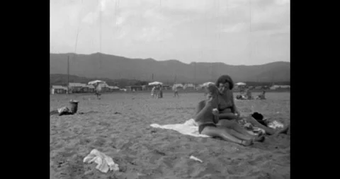 Russia - circa 1970s: Soviet Union beach, mother and son sitting on sand Stock Footage 324967691