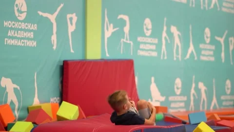 RUSSIA-DEC 18, 2022: active gymnastics school training fitness exercise frog Stock Footage 229432253