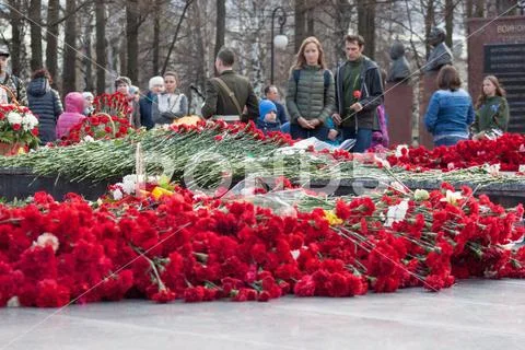 Russia, Izhevsk - May 9, 2018: Red carnation flowers on memorial marble board Stock Photos