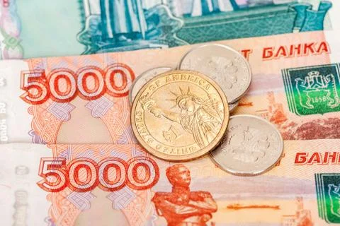 Russian and american coins over banknotes close up Stock Photos