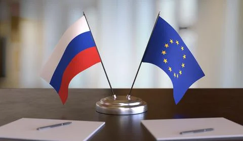 Russian and EU flags on table. Negotiation between European Union and Russia. 3D Stock Photos