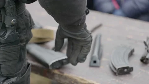A russian army instructor standing and assembling gun. Stock Footage 130396369