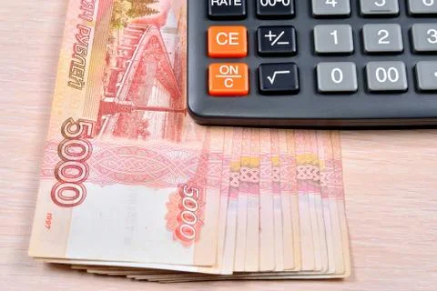 Russian banknotes five thousand rubles and the calculator are on the table Stock Photos