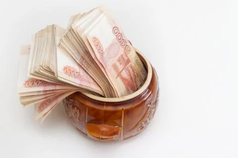 Russian banknotes of five thousand rubles in large quantities in a ceramic po Stock Photos