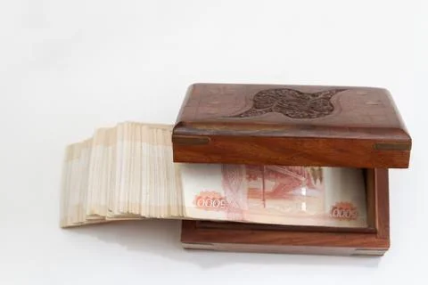 Russian banknotes of five thousand rubles in large quantities in a wooden box Stock Photos