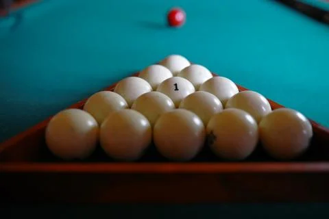 Russian billiard balls, cue, triangle, chalk on a table Green cloth Copy spac Stock Photos