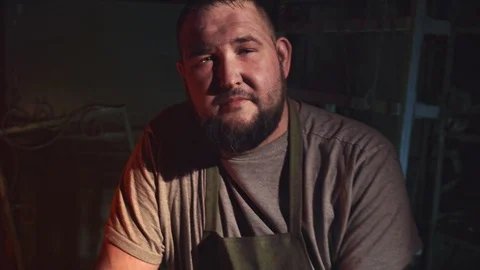 Russian blacksmith in his forge. Smoke break at a workplace Stock Footage 108032571