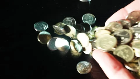Russian coins fall from the hands on the table. Russian ruble Video stock 172987151