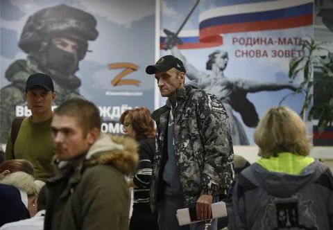 Russian conscripted men at a Moscow recruiting office during Russia's partial mi Stock Photos