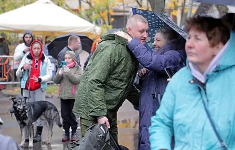 Russian conscripted men at a Moscow recruiting office during Russia's partial mi Stock Photos