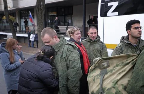 Russian conscripted men at a Moscow recruiting office during Russia's partial mi Stock Photos