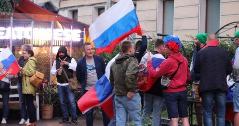 Russian crowd standing in wind in street waving flag Stock Footage 91697185