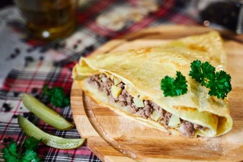 Russian cuisine. Pancakes with meat and potatoes Stock Photos