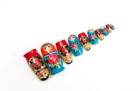 Russian doll. Wooden dolls on a white background lie to size Stock Photos