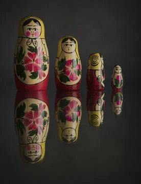 Russian Dolls Reflected in a shiny surface Stock Photos