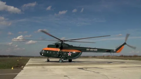 Russian DOSAAF helicopter Mi-8 (NATO: "Hip") moves towards concrete runway. Stock Footage 139399843