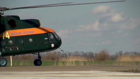 Russian DOSAAF helicopter Mi-8 (NATO: "Hip") moves towards concrete runway. Stock Footage 139761801