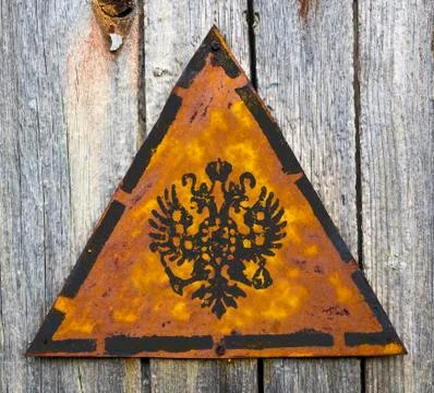 Russian Double Eagle on Rusty Warning Sign. Stock Illustration