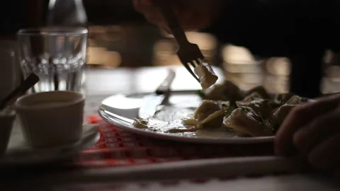 Russian dumplings on a plate Close-up, hands Fork Stock Footage 150274593