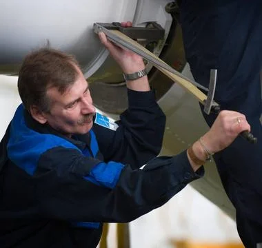 Russian engineers attach the escape tower to the Soyuz TMA-14 spacecraft a... Stock Photos