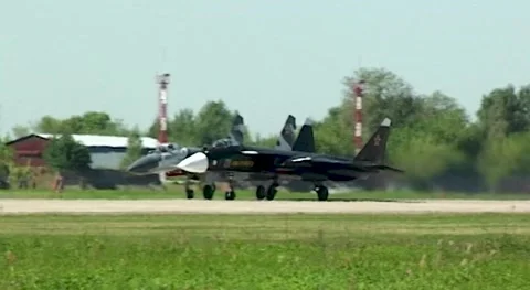 Russian fighter Su-47 Berkut (NATO - Firkin) and Su-30SM accelerate down runway. Stock Footage 196156410