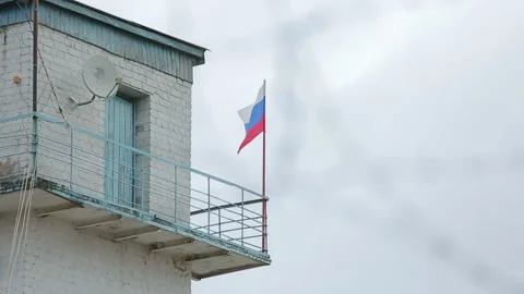 The Russian flag on a background sky and barbed wire with prefocused Video stock 98358953