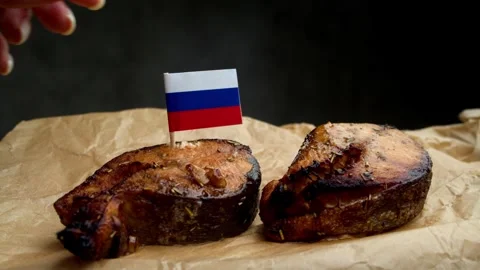 Russian flag on fish steak, symbol of local Russian sea and river fish. Stock Footage 323013624