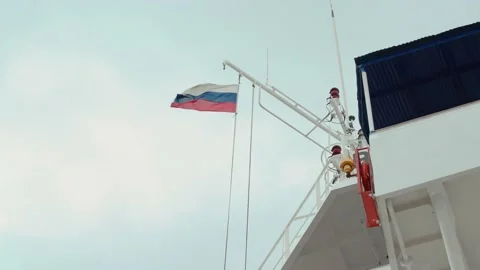 Russian flag on a flagpole flies in the wind on the deck of a ship Stock Footage 159597513