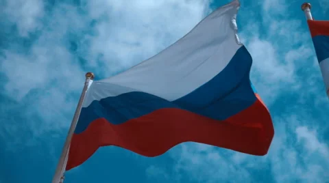 Russian flag on the flagpole waving in the wind against a blue sky with clouds Stock Footage 64713667