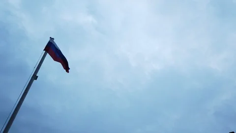 Russian flag on the flagpole waving in the wind against a blue sky with clouds Stock-Footage 113821830